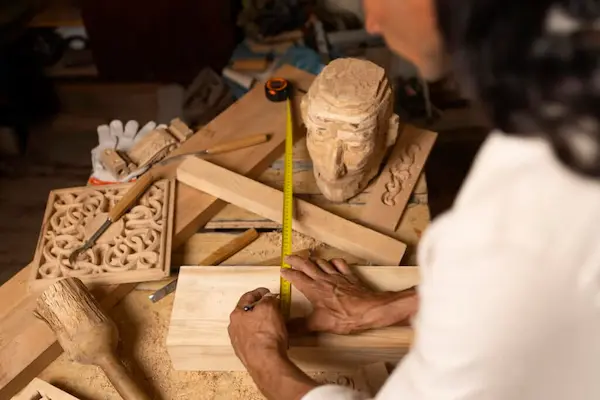 Artesanas adultas mayores elaborando productos decorativos de madera con técnicas tradicionales